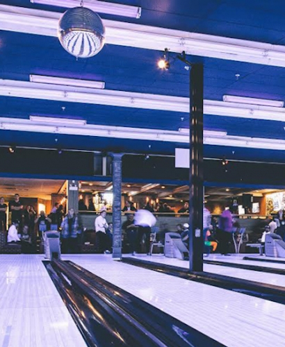 People bowling at a bowling alley in Charlottetown PEI, a fun indoor activity perfect for a rainy day
