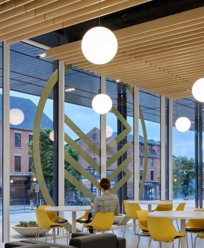 Interior of the Charlottetown Library Learning Centre in PEI with bookshelves and seating areas, a cozy indoor space for a rainy day