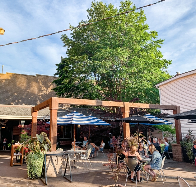 Guests dining on the outdoor waterfront patio at The Pilot House in downtown Charlottetown, Prince Edward Island.