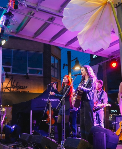 Live music performance by two artists on stage in downtown Charlottetown during street feast