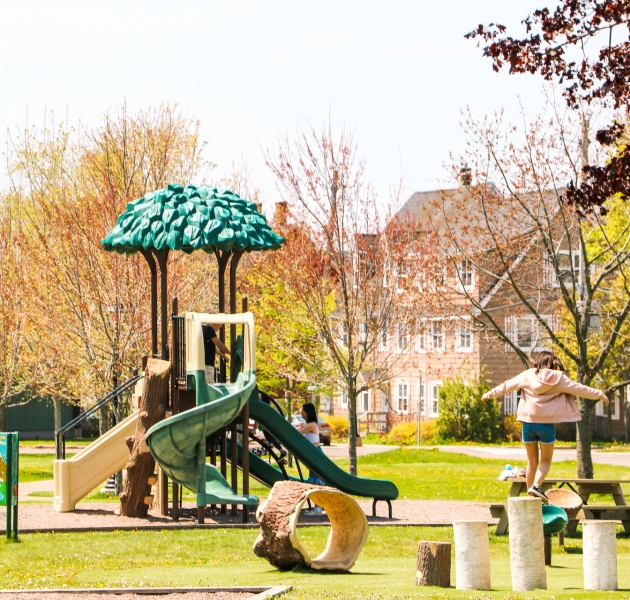 Green space and walking paths in Connaught Square in Charlottetown, Prince Edward Island, surrounded by historic neighbourhood homes.