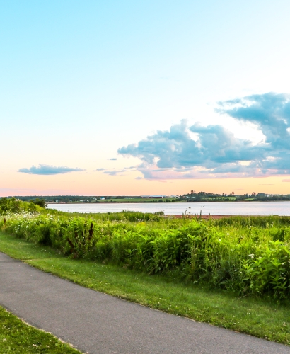 Green space at Queen Elizabeth Park in Charlottetown, Prince Edward Island, overlooking the waterfront at sunset.