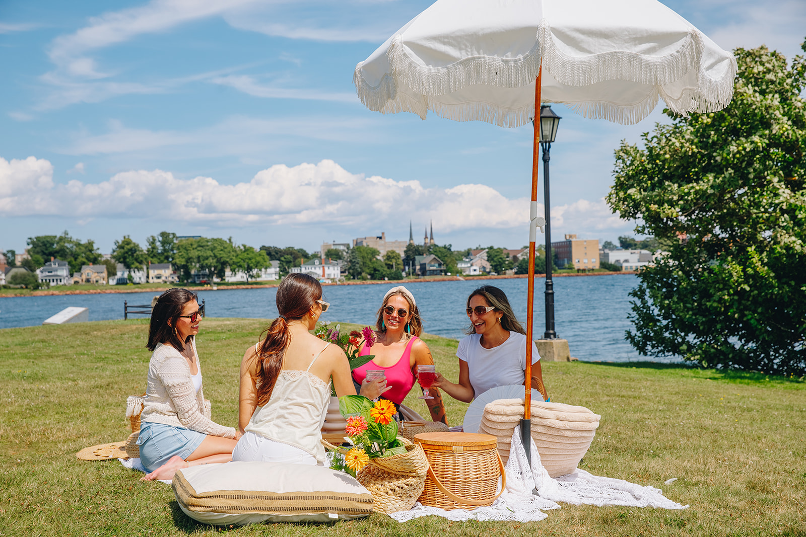Group of friends enjoying a picnic in Victoria Park in Charlottetown, Prince Edward Island, on a sunny day near the waterfront.