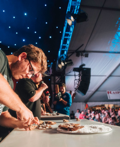 Chefs preparing fresh seafood dishes during the Prince Edward Island Shellfish Festival in Charlottetown, Prince Edward Island, with oysters, mussels, and lobster being served.