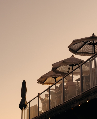 Guests enjoying food and drinks on the deck patio at Salt & Sol overlooking Charlottetown waterfront in Prince Edward Island.