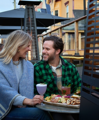 Guests seated and socializing on the outdoor patio at Slaymaker & Nichols in downtown Charlottetown, Prince Edward Island.