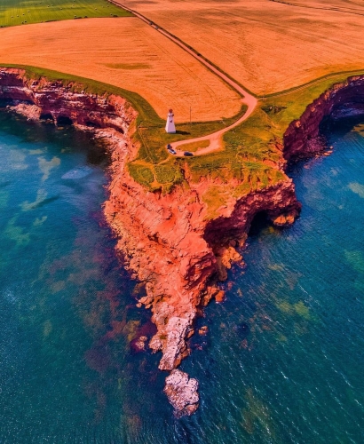 Red sand cliffs along the coast of Prince Edward Island near Charlottetown, with rugged shoreline and ocean views