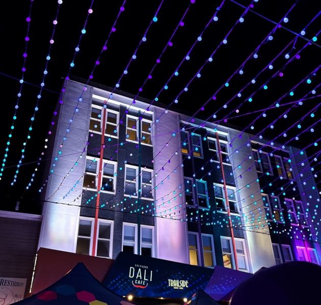Colourful lights illuminating Kent Street in downtown Charlottetown, Prince Edward Island, at night with a lively urban atmosphere.