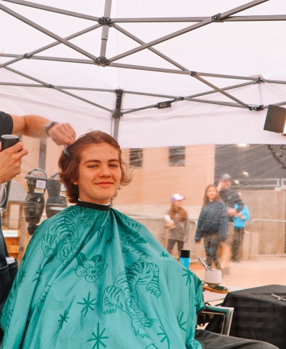 Barber giving a haircut at a street feast festival in Charlottetown, Prince Edward Island