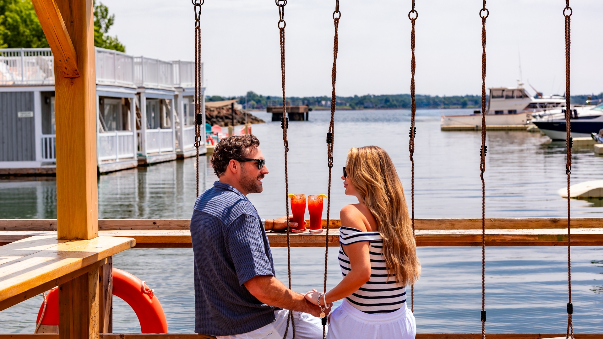 Floating dock patio at JC Tiki Bar on the Charlottetown waterfront in Prince Edward Island with harbour views and outdoor seating.