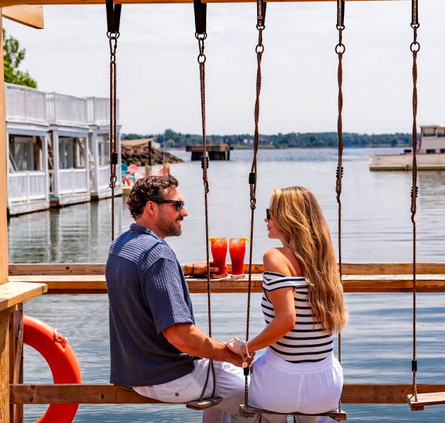 Floating dock patio at JC Tiki Bar on the Charlottetown waterfront in Prince Edward Island with harbour views and outdoor seating.