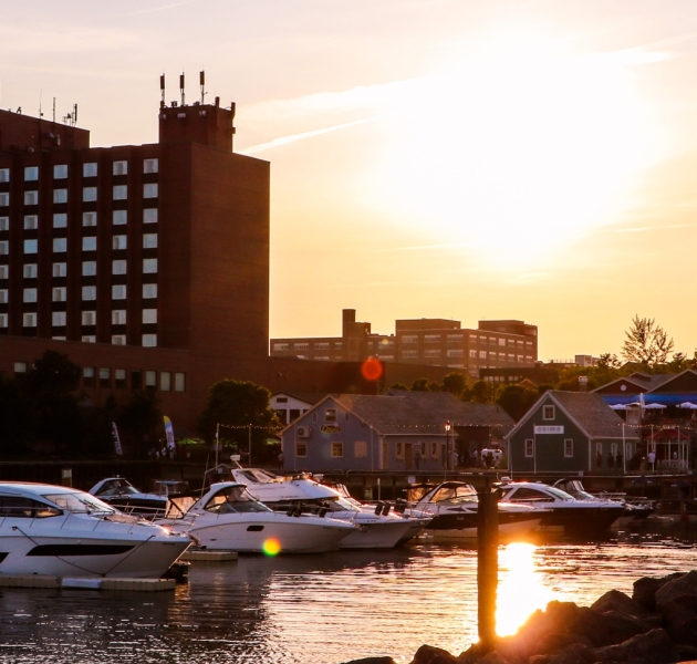 Boats docked near Peake’s Quay at sunset in Charlottetown, Prince Edward Island, with harbour views and warm evening light.